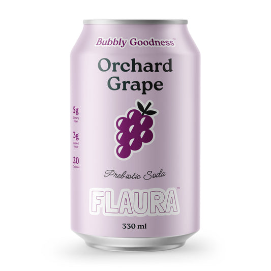 A 330 ml can of FLAURA Orchard Grape Prebiotic Soda. The can features a light lavender-purple metallic finish with a dark purple illustration of an orchid grape cluster in the center.